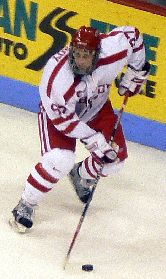 BU's Matt Gilroy carries the puck around the Northeastern net.