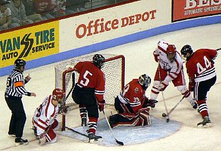Boston University and Northeastern players scramble around the net in overtime (photos: Scott Weighart).