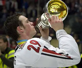 Jonathan Toews hoists Canada's gold-medal trophy (photo: Melissa Wade).