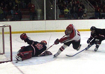 Lake Forest's Scott Campbell stops a breakaway attempt by MSOE's Blair Hanberg during the second period of Lake Forest's 4-3 win on Saturday. (Photo by Matthew Webb)