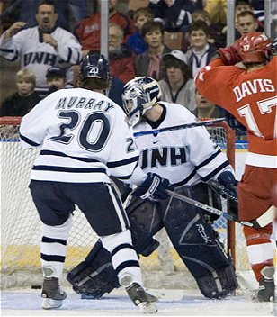 Kevin Regan (c.) looks behind him at Nathan Davis' (r.) goal Saturday in Miami's upset of UNH (photo: Melissa Wade).