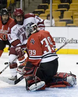 Brad Thiessen makes a stop on Jon Pelle during last year's Beanpot (photo: Melissa Wade)>” /></p>
<div class=