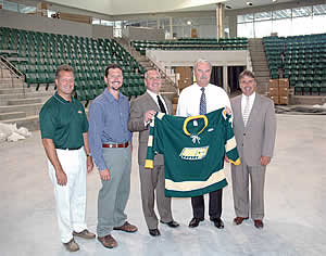 The Pathfinder Bank Oswego Hockey Classic will feature four of the best teams in NCAA Division III men's hockey at the Campus Center hockey arena this December. In the new arena as construction progresses are, from left, Oswego head coach Ed Gosek, Shane Broadwell of the Best Western Captain's Quarters and Econo Lodge Inn & Suites, Pathfinder Bank President and CEO Tom Schneider, Oswego Athletic Director Timothy G. Hale, and Oswego Blueline Club president Mike Cullinan. (courtesy Oswego Sports Information.)