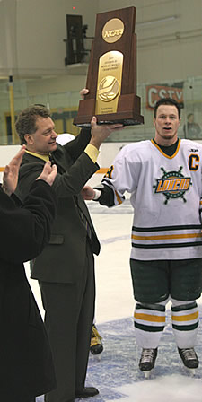 Ed Gosek and Oswego captain Ryan Woodward hoist the D-III trophy in Superior, Wis., on March 18. (photo: Larry Radloff/Oswego State Sports Information)