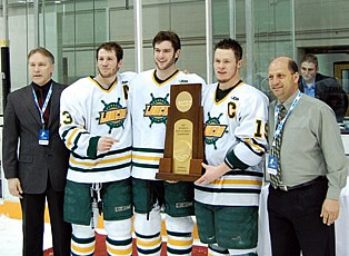 Team captains Tony DiNunzio (13), C.J. Thompson (16), and Ryan Woodward (19) accept the NCAA trophy.