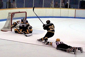 St. Norbert's Ryan Petersen finishes off a breakaway in St. Norbert's 7-5 win over UW-Stevens Point. (photo: Kelly Vant)