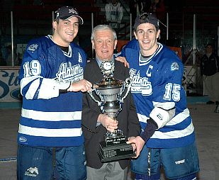 UAH co-captains Grant Selinger (left) and Shaun Arvai accept the McLeod Trophy from CHA commissioner Bob Peters.