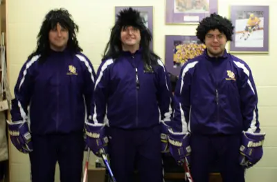 Elmira volunteer assistant coach Greg Moore (left), head coach Tim Ceglarski (center), and assistant coach Dean Jackson sport their hippy hair (photo: David Walberg, Elmira Sports Information Assistant).