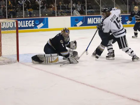 Notre Dame goalie Jordan Pearce, show making one of 32 saves against New Hampshire in the 2008 regionals, says that the successful Irish hockey season has helped school spirit after a down year on the gridiron (photo: Candace Horgan.)