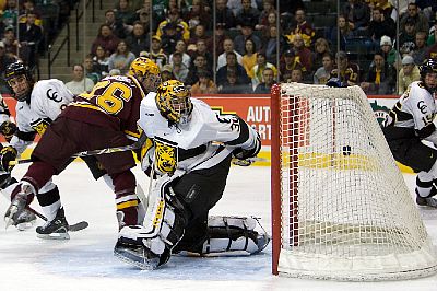 Jay Barriball crosses in front of Richard Bachman as Mike Hoeffel's winning goal lands in the net (photo: Jim Rosvold / University of Minnesota).