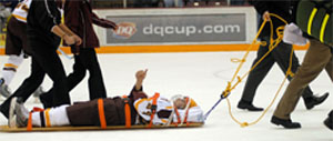 Mike Howe signals to the crowd while being taken off the ice in the first period Saturday.  Early reports indicated no serious injury despite a scary few minutes (photo: Jason Waldowski).