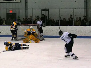 Blue Devils' defenseman Jack Wolgemuth gets off the game-winning shot in the final minute of the game (photo: Matthew Webb).