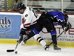 RMU's Nathan Longpre (left) maintains possession of the puck during last weekend's action against UAH (photo: Robert Morris).