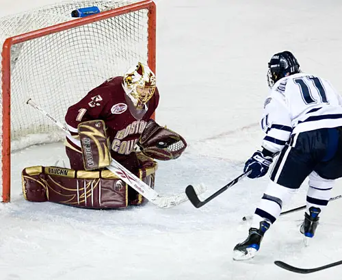 John Muse gloves the puck on Jerry Pollastrone (photo: Melissa Wade).