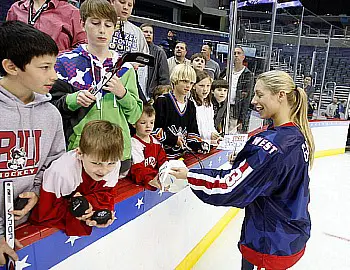 Melanie Gagnon of Minnesota signs autographs for some of the young fans at the Skills Challenge (photo: Jim Rosvold).