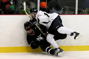 Hobart sophomore Tom Capalbo crunches a Nichols player along the boards (photo: Angelo Lisuzzo).