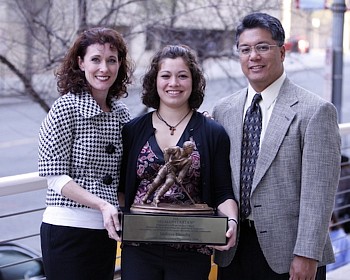 Elumba with the Humanitarian Award, flanked by her parents (photo: Jim Rosvold).