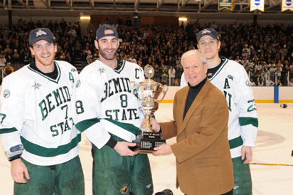 With the McLeod Trophy are (l-r) Cody Bostock, Travis Winter, former CHA commissioner Bob Peters and Chris McKelvie (photos: BSU photo services).