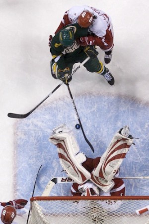 Wisconsin goaltender Scott Gudmandson falls to the ice after making a save (photo: Jim Rosvold).