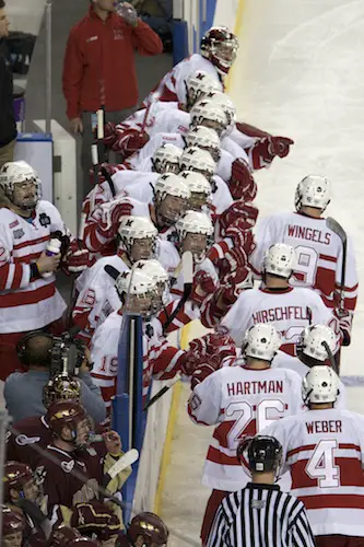 Miami's Joe Hartman (26) gets greeted at the bench along with linemates after his goal cut the RedHawks' deficit to 3-1 in the third period Thursday (photo: Jim Rosvold).