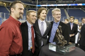 Wisconsin assistant coach Mark Osiecki, coach Mike Eaves, Blake Geoffrion and assistant coach Kevin Patrick pose with the Hobey Baker Award (photo: Jim Rosvold).