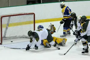 Jason Gorrie falls to the ice after sliding the puck around the goalie for a 2-0 lead (photo: Angelo Lisuzzo).