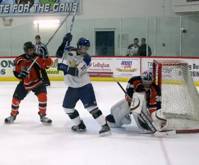 Salem State goalie James LaCour and St. Scholastica forward Brett Corcoran (photo: Matthew Webb).