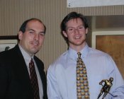 ECAC Commissioner Phil Buttafuoco (left) presents the Defensive Forward of the Year Award to Cornell's Doug Stienstra.