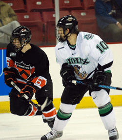 ECAC Hockey Player of the Year Lee Jubinville races up-ice alongside UND's Andrew Kozek, who scored the winning goal (photo: Tim Brule).