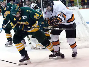 Kevin Lohry (Princeton - 12) tries to take the puck away from Jake Morley (Clarkson - 14). (Shelley M. Szwast)