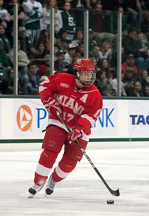Andy Miele skates up the ice with the puck. Miele scored one goal and received an assist against Michigan State.. (Erica Treais)
