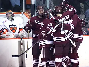 Photo By: Shelley M. Szwast Colgate's Robbie (Colgate - 17) Bourdon celebrates his third period goal with teammates, as the Colgate Raiders cut the Princeton lead to 5-4. (Shelley M. Szwast)