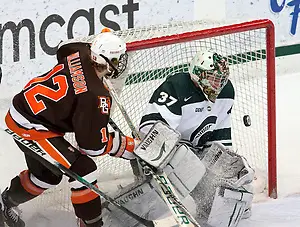 Michigan State freshman goaltender Will Yanakeff prepares to stop the puck as Bowling Green forward Bryce Williamson follows it with his eyes. Yanakeff only allowed one goal in against the Falcons, leading Michigan State to a 2-1 defeat. (Erica Treais)