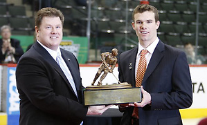 Chuck Long presents the 2011 Hockey Humanitarian Award to Brooks Dyroff of Boston College.. (Jim Rosvold)