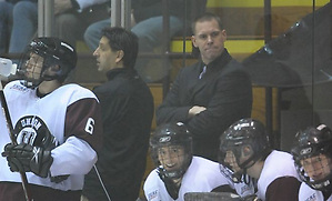Union associate head coach Rick Bennett (back, standing) watches over the bench. (Union Athletics)