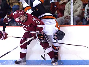 Brodie Zuk (Princeton - 19) gets flipped by Danny Biega as he was checked along the boards. (Shelley M. Szwast)