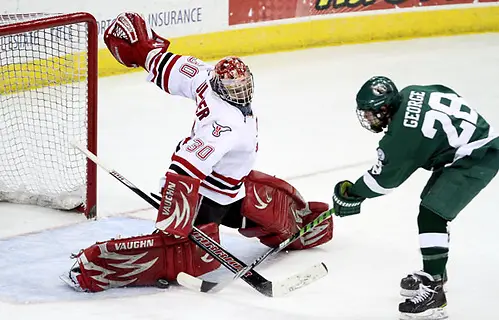 Photo By: Michelle Bishop Nebraska-Omaha goalie John Faulkner stops Bemidji State's Jordan George during a breakaway in the second period. Bemidji State beat UNO 3-2 Saturday night at Qwest Center Omaha to win the best-of-three WCHA first-round series. (Photo by Michelle Bishop) (Michelle Bishop)