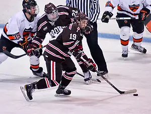 Matt Lorito (Brown - 19) plays the puck as Rob Kleebaum (Princeton - 39) and Chris Zaires (Brown - 22) battle. Princeton and Brown tied 2-2 at Hobey Baker Rink in Princeton, N.J. (Shelley M. Szwast)