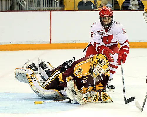 Minnesota goaltender Noora Raty jumps on a loose puck in front of Wisconsin's Katy Josephs in the third period of the National Championship game.  Raty stopped 42 of 44 shots she faced Sunday, including 20 in the third period, and was named the Frozen Four Most Outstanding Player. (2012 Dave Harwig)
