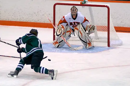 Photo By: Omar Phillips Mercyhurst's Kristine Grenier gets a 2nd period shot off against RIT's Ali Binnington. Grenier had one assist in a 6-2 win. (Omar Phillips)