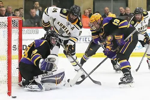 Photo By: Mike Dickie Photography Wisconsin-Stevens Point goaltender Max Milosek makes a save with Adrian's Daniel Lisi and the Pointer's Nathan Harris in front. (Mike Dickie Photography)