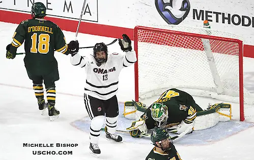 Photo By: Michelle Bishop Omaha's Jake Randolph (13) celebrates Luc Snuggerud's goal during the second period. Omaha and Vermont skated to a 4-4 tie Friday night at Baxter Arena. (Photo by Michelle Bishop) (Michelle Bishop)
