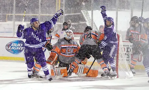 Photo By: Omar Phillips TJ Sarcona (21, left), Hugo Turcotte (19) - RIT and Niagara skated to a 2-2 tie at the Frozen Frontier, an outdoor hockey event in Rochester, NY. (Omar Phillips)