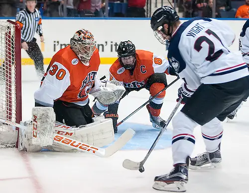 Jeff Wight (21 - UConn) tries to get a shot off on Mike Rotolo (30 - RIT) (Omar Phillips)