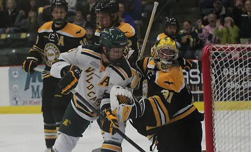 Northern Michigan University junior forward Reed Seckel (9) watches the shot of senior forward Stephan Vigier (not pictured) trickle past Michigan Tech goaltender Pheonix Copley during the first period on Friday, Oct. 25, 2013 at the Berry Events Center in Marquette. Vigier was credited with the goal and Seckel an assists. (Photo by Adelle Whitefoot) (Adelle Whitefoot)