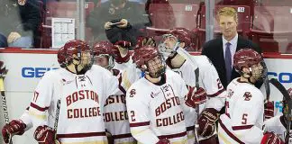 Kevin Lohan (BC - 24) was mobbed by teammates on his return to the bench after scoring his first goal as an Eagle. The grad student transferred to BC from Michigan. His two goals tonight doubled his career totals. The Boston College Eagles clinched the Hockey East regular season championship with their 6-3 win over the visiting University of Maine Black Bears on Friday, February 23, 2018, at Kelley Rink in Conte Forum in Chestnut Hill, Massachusetts. (Melissa Wade)