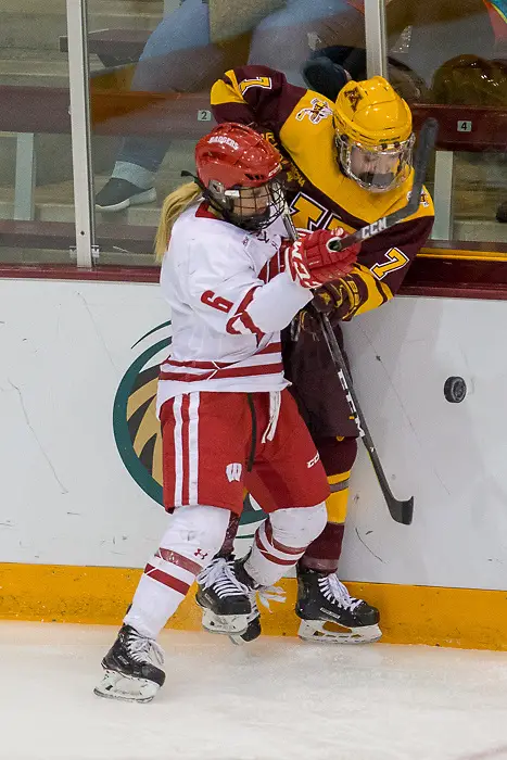 Taylor Williamson is checked by Presly Norby. The University of Wisconsin Badgers play against the University of Minnesota Golden Gophers in the Championship game of the 2018 WCHA Final Faceoff game at Ridder Arena in Minneapolis, MN. (Jim Rosvold/WCHA)