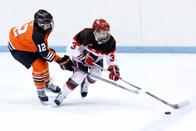 Nadine Edney (St. Lawrence - 3) plays the puck as Morgan Sly ( Princeton - 12) defends. (Shelley M. Szwast)