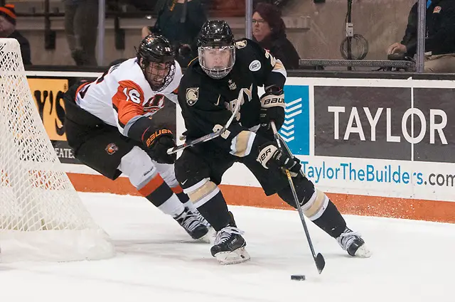 Dalton MacAfee (2 - Army West Point) shields the puck from Erik Brown (16 - RIT) (Omar Phillips)
