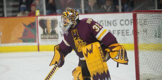 Hunter Shepard of UMD plays the puck. Minnesota Duluth at Denver at Magness Arena, November 17, 2018. (Candace Horgan)